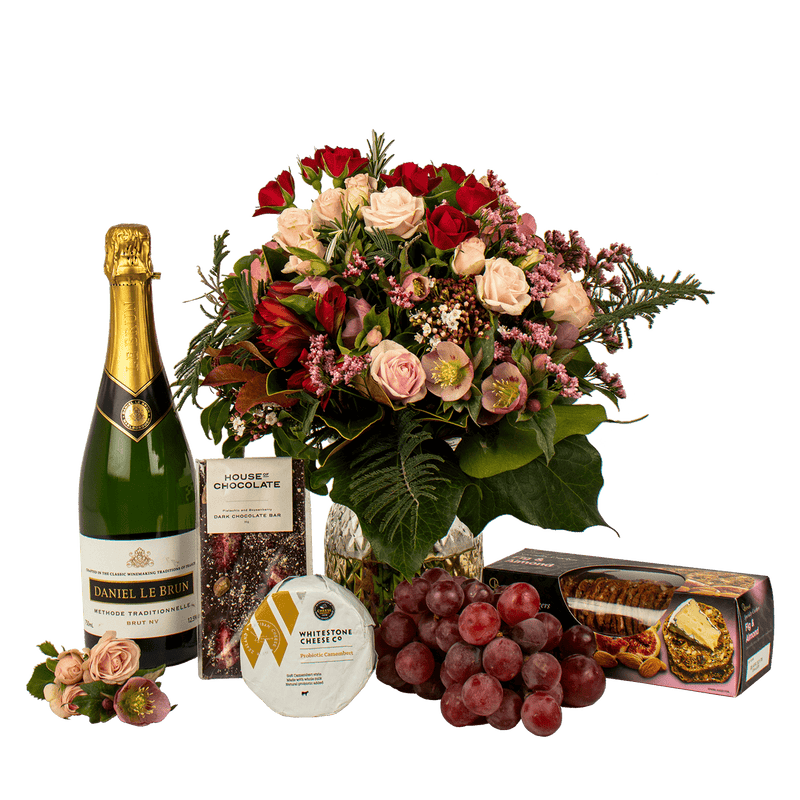 Gift basket with champagne chocolate cheese crackers flowers and fresh fruit